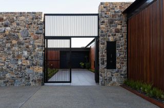 The entrance approach with black gate, Tinderbox House by Studio Ilk Architecture