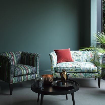 living room with bottle green wall and sofa