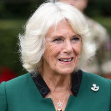 Queen Camilla wearing a green coat