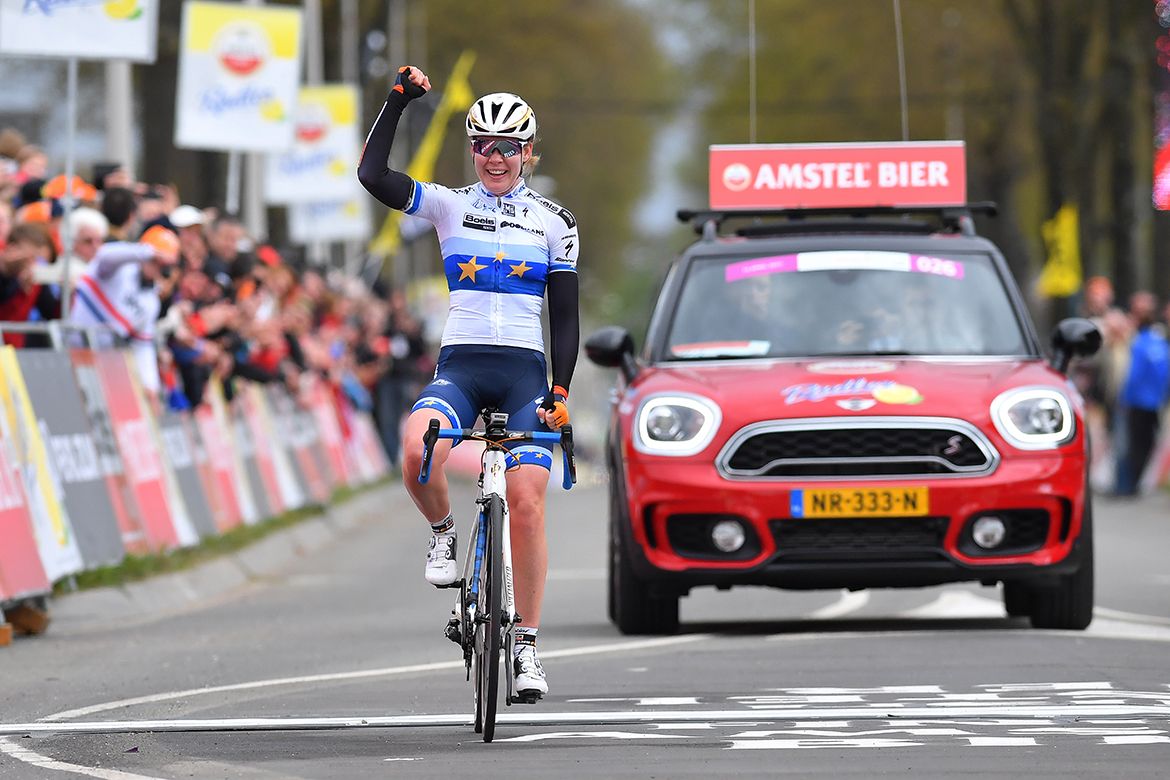 Anna van der Breggen sits up and celebrates