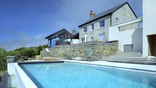 swimming pool outside extended cottage