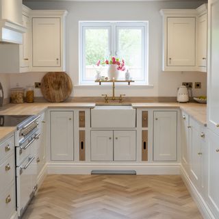 white shaker kitchen with wooden worktops and floors