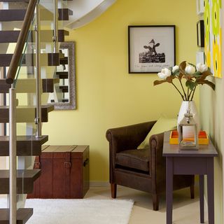 hallway with yellow wall and wooden staircase