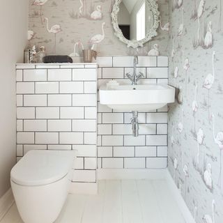 bathroom with wallpaper on wall and mirror