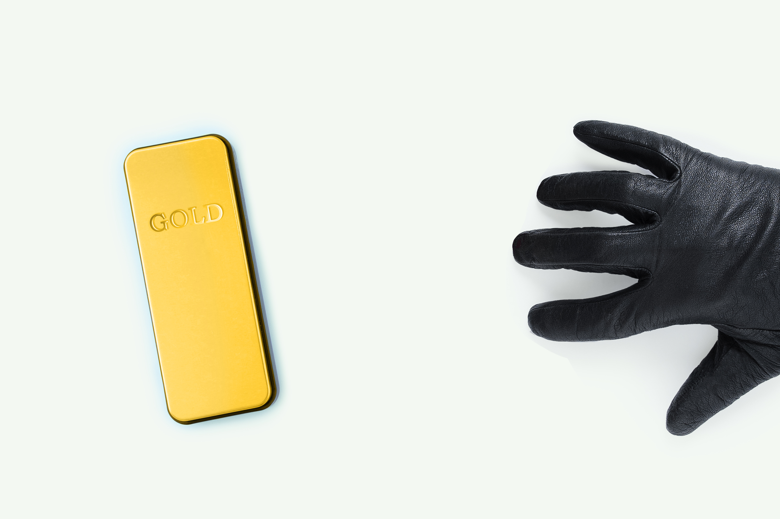 Gloved hand reaching for gold bar