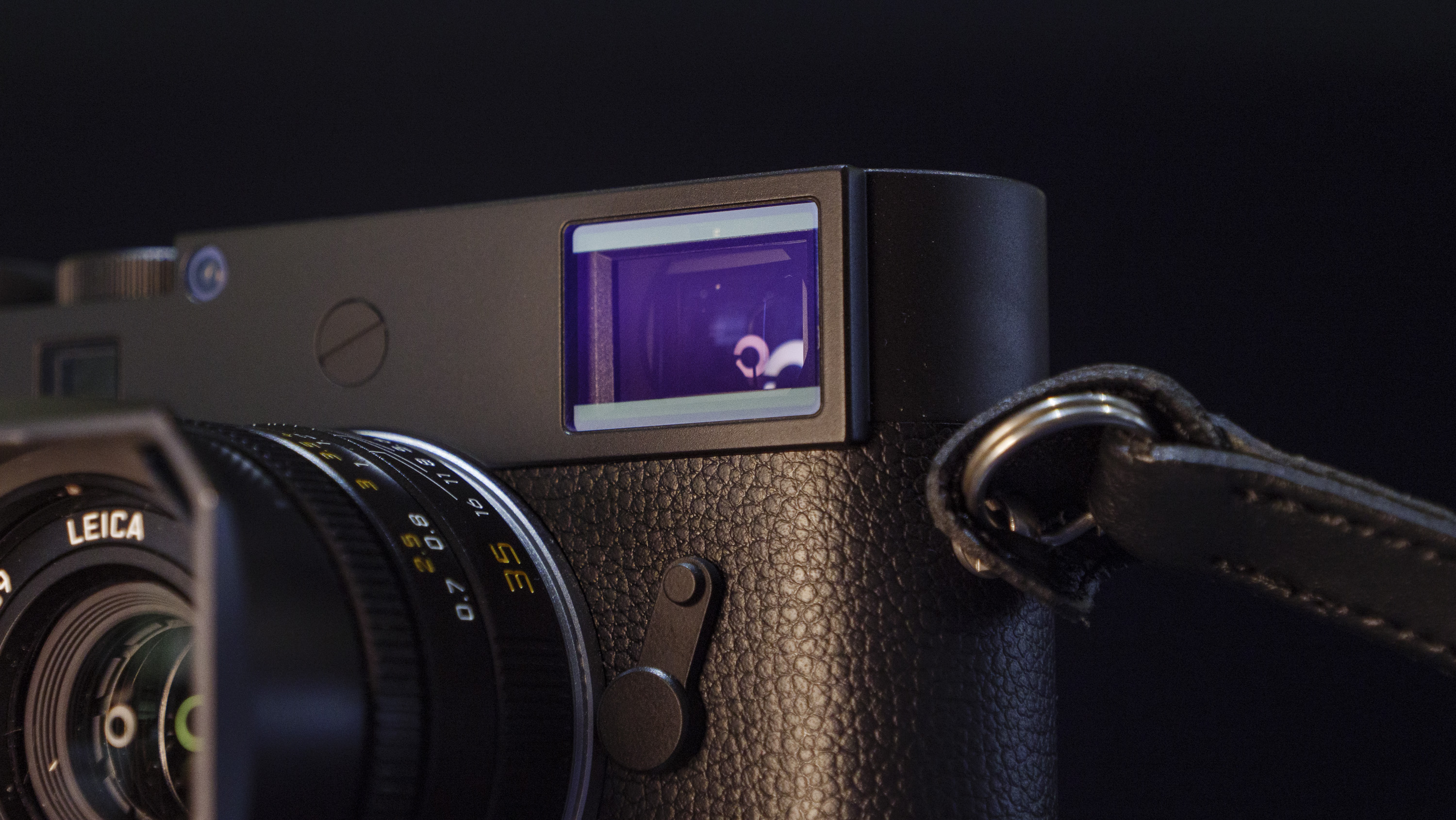 Leica M11-D camera on a dark blue table, low key lighting, close up of viewfinder