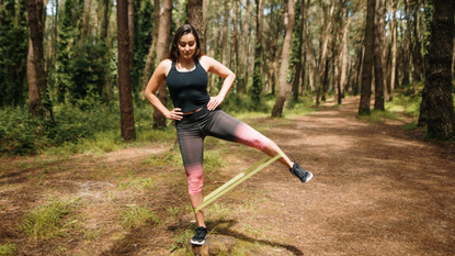 Woman doing resistance band workout outdoors