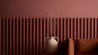 Red living room wall painted in Graham & Brown's colour of the year to show 2023 paint color trends to watch