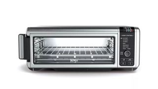 A silver and black Ninja Foodi oven on a white background