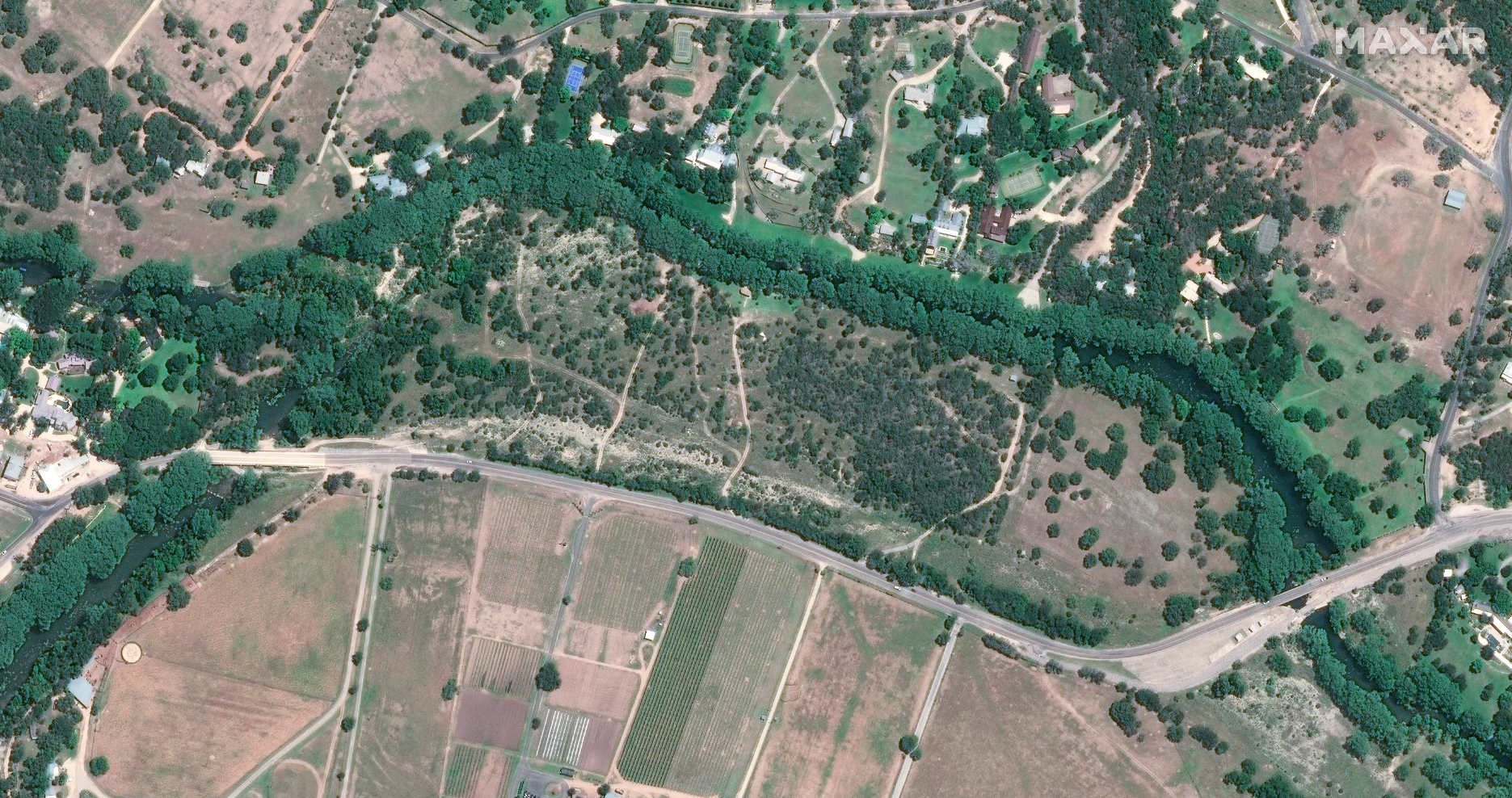 A satellite image of green vegetation beside the Guadalupe River on June 23, 2023.
