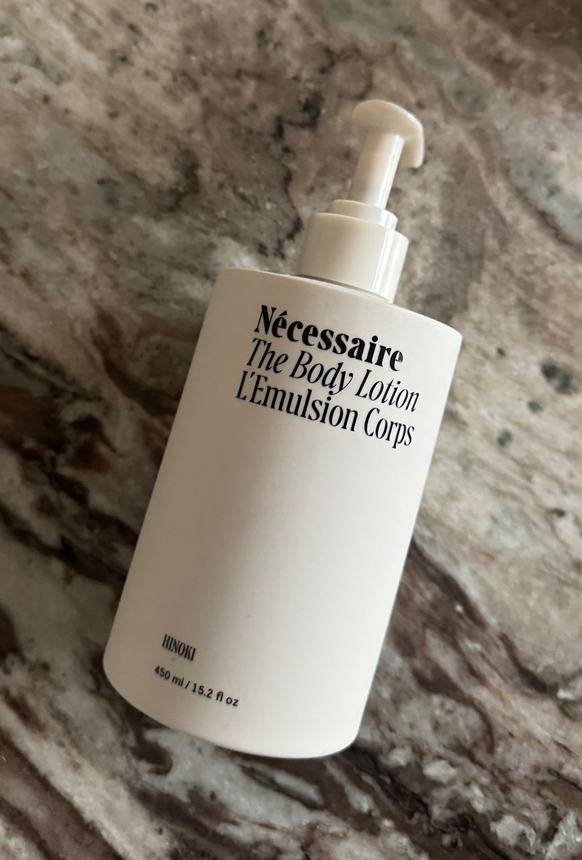 Necessaire Hinoki body lotion on a marble table