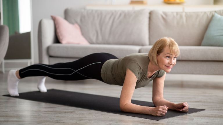 Why are core muscles important? Image shows woman doing plank position at home