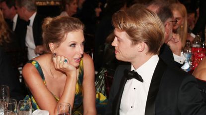 Taylor Swift and Joe Alwyn sitting together at the 77th Golden Globe Awards