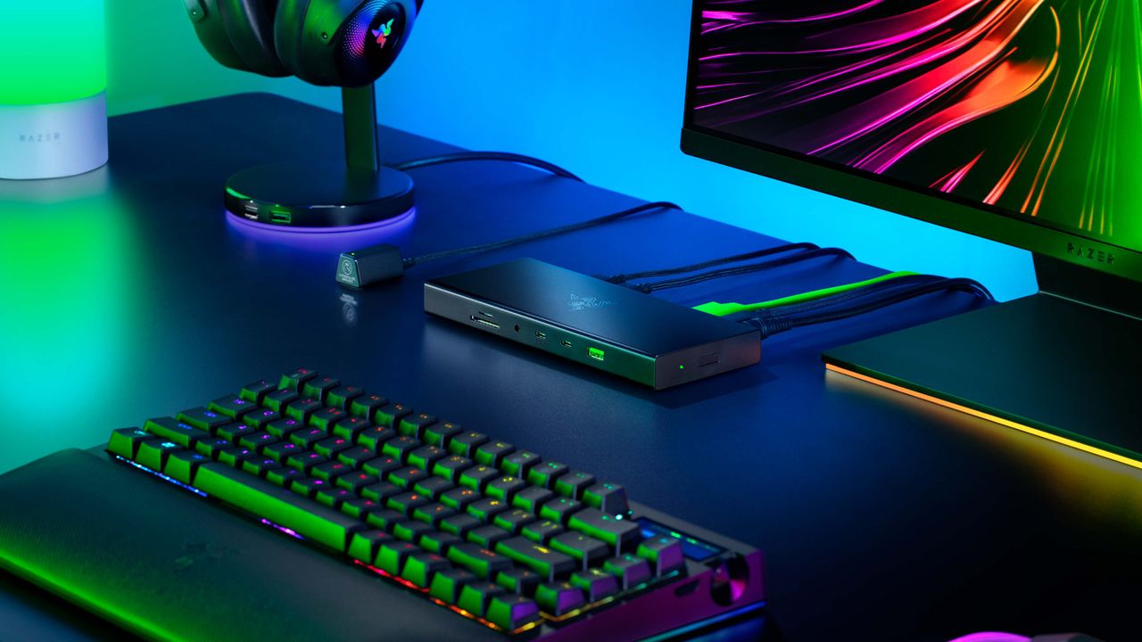 The Razer USB4 Dock on a black desk with other Razer accessories.