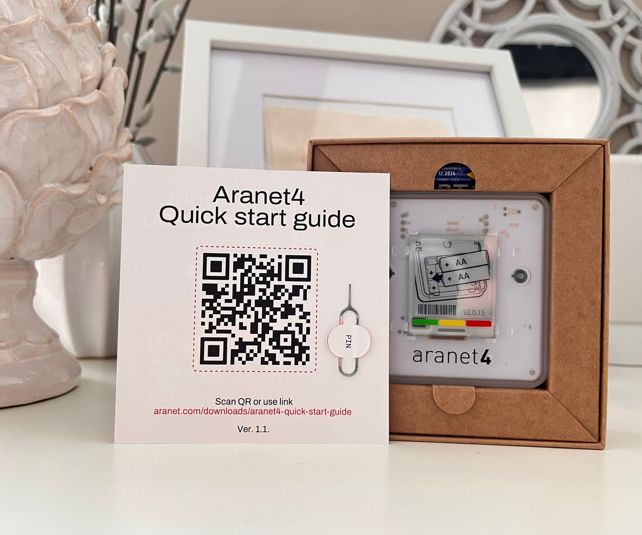 Aranet4 home monitor in box with start guide in front of it