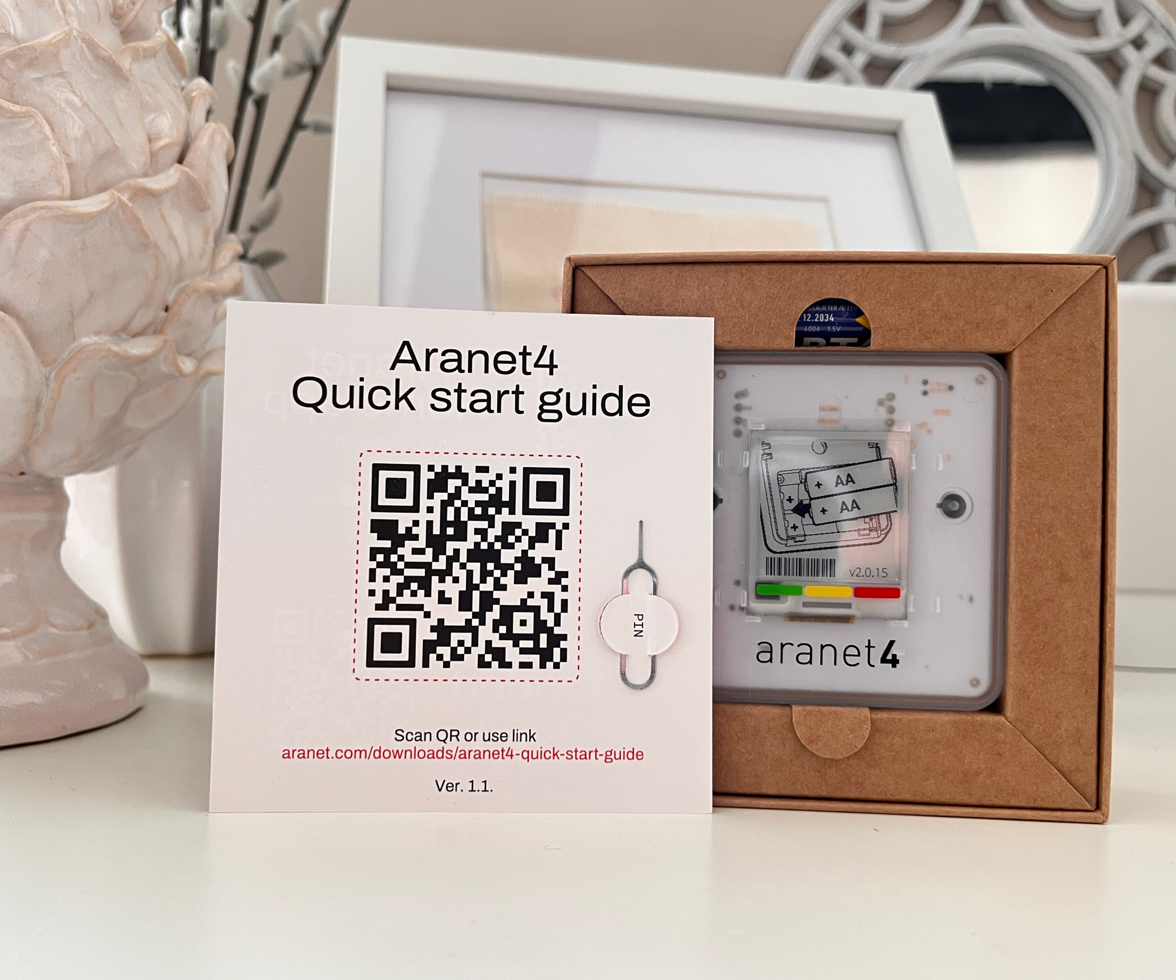 Aranet4 home monitor in box with start guide in front of it