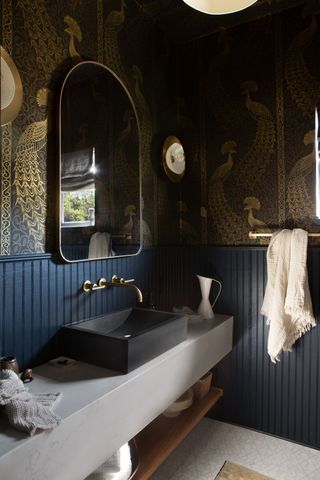 dark powder room with printed wallpaper by Urbanology