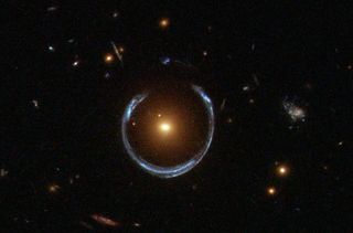 The blue ring is light from a more distant galaxy, distorted by the red galaxy at the centre.