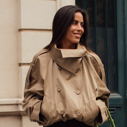 woman wearing a tan trench in Paris
