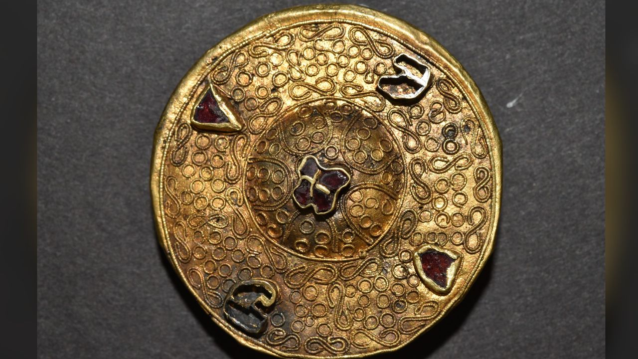 This gold brooch was found buried next to a woman who was buried not far from the rider with headless horse. The relationship between this woman and the rider is not clear.