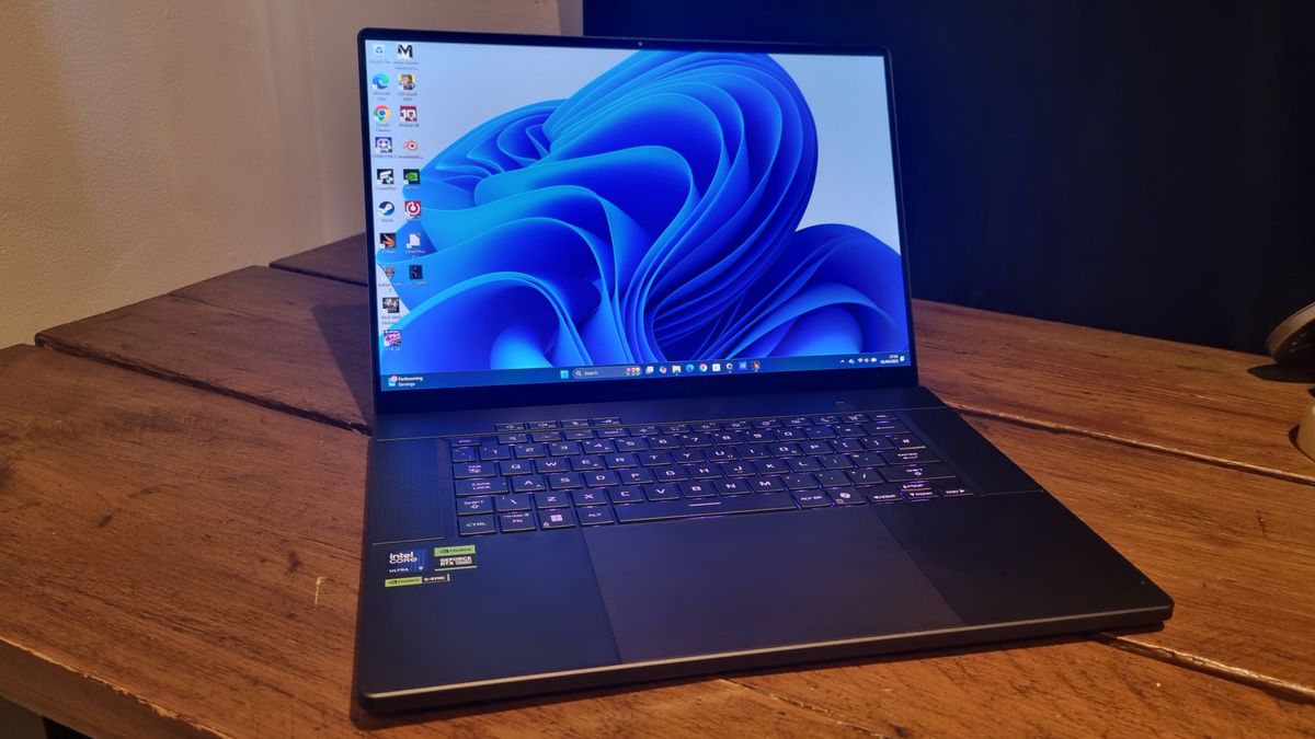 The Asus ROG Zephyrus G16 gaming laptop open on a wooden desk