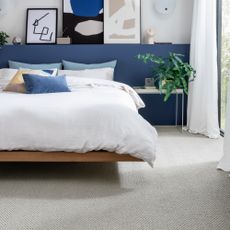 how to decorate a guest room, floating bed with blue headboard design, metal side table, artwork, carpet 