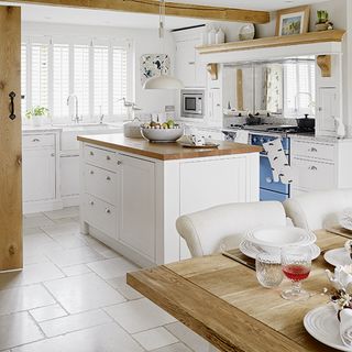 kitchen area with white wall and wooden worktop