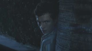 Patrick Gibson as Dexter Morgan leaning against a tree nervously in the dark in Dexter: Original Sin