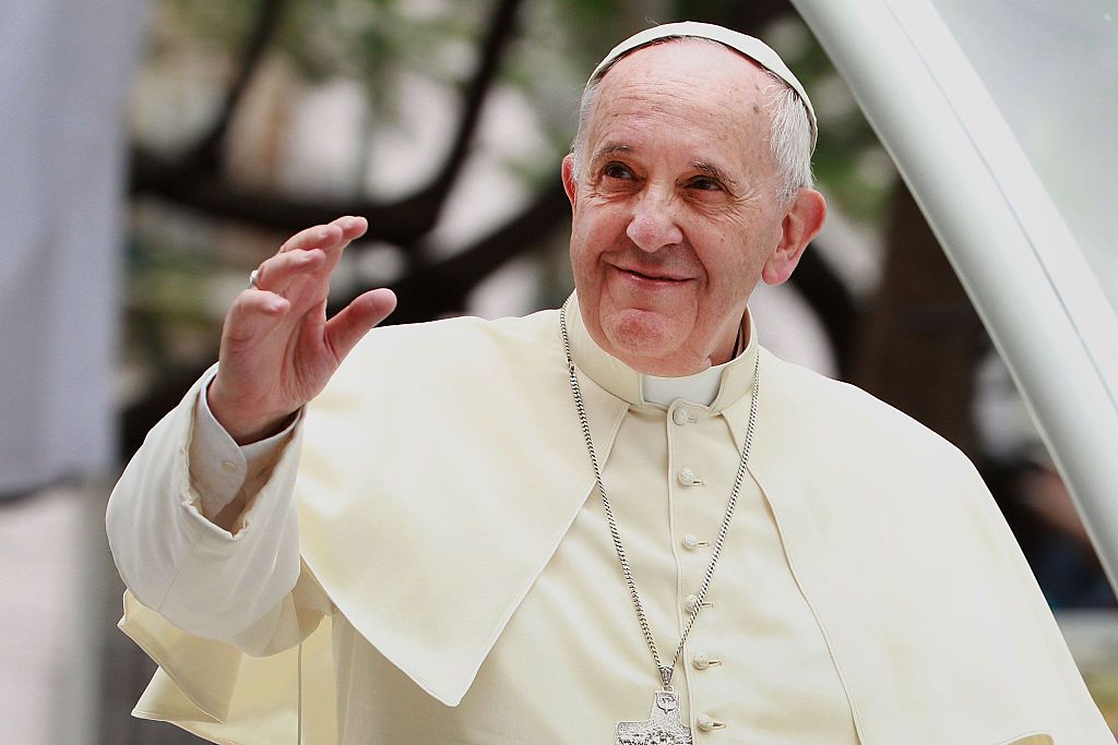 Pope Francis waves to thousands of followers as he arrives at the Manila Cathedral on January 16, 2015 in Manila, Philippines.