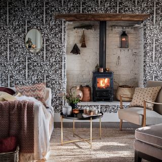 Brown living room idea with woodland wallpaper and a log burner