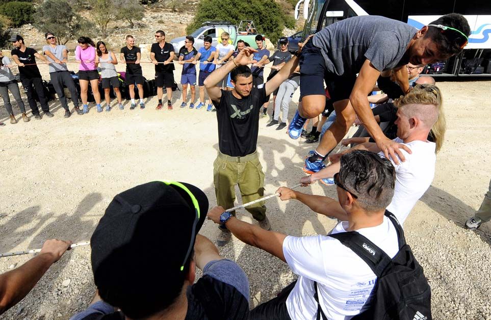 Ahmet Orken attempts to run around a rope held up by his new team