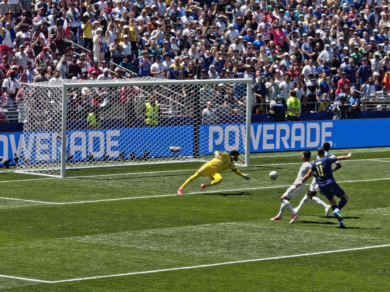 A goalie diving to block a goal