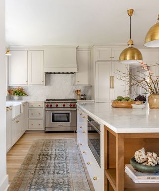 modern neutral kitchen with Shaker cabinets and marble island and gold pendant light