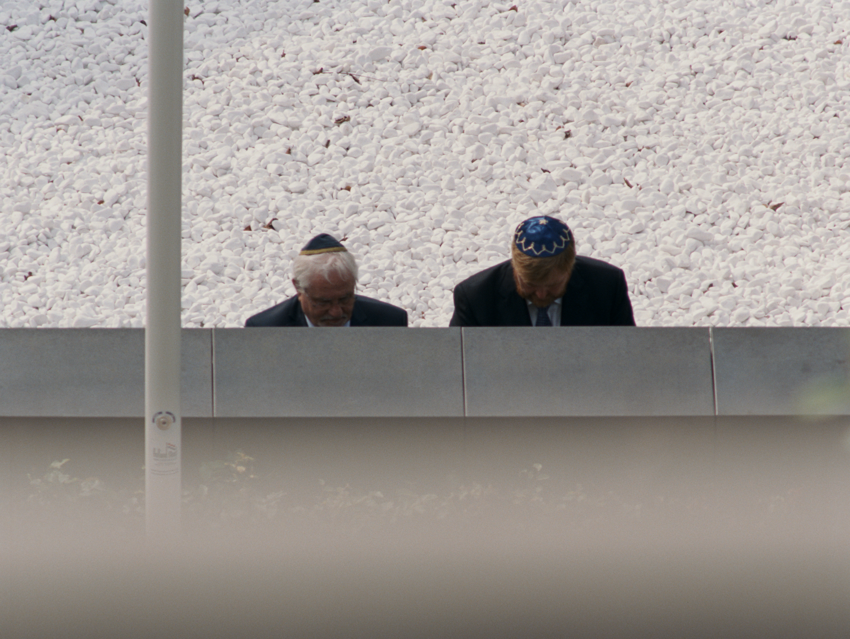 film still of two men in skull caps