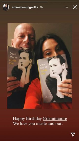 Bruce Willis and Emma Heming posing with Demi Moore's memoir Inside Out in a birthday post