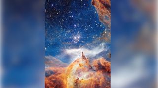Glowing clouds of orange and blue dust swirl around three bright stars