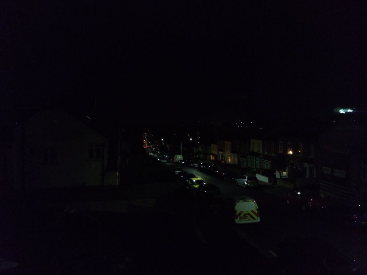 Auto mode just doesn&rsquo;t cut it for very dark scenes like this. You can barely tell what this street scene is.
