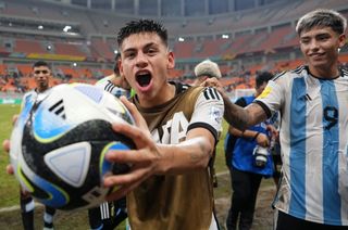 Claudio Echeverri of Argentina celebrates with the match ball following the team's victory in the FIFA U-17 World Cup Quarter Final match between Argentina and Brazil at Jakarta International Stadium