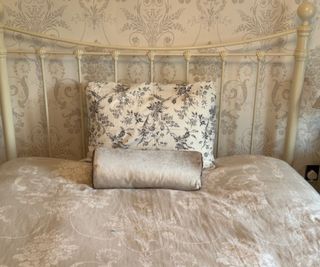 The Marlow Pillow in a case on a bed.