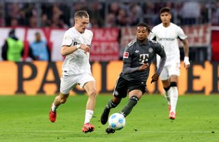 MUNICH, GERMANY - SEPTEMBER 28: Florian Wirtz of Bayer 04 Leverkusen runs with the ball whilst under pressure from Michael Olise of Bayern Munich during the Bundesliga match between FC Bayern München and Bayer 04 Leverkusen at Allianz Arena on September 28, 2024 in Munich, Germany. (Photo by Alexander Hassenstein/Getty Images) Manchester City target