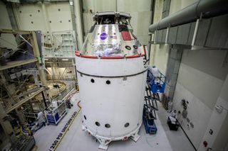 The Orion spacecraft for NASA’s Artemis I mission is in view inside the Neil Armstrong Operations and Checkout Building high bay on Oct. 28. Attached below Orion are the crew module adapter and the European Service Module with spacecraft adapter jettison fairings installed.