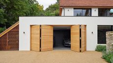 Urban Front craft beautiful bifold doors using natural hardwood - for a luxury but practical contemporary style statement. Parma design, double bi-fold. European oak w 5400mm x h 2400 on a white garage
