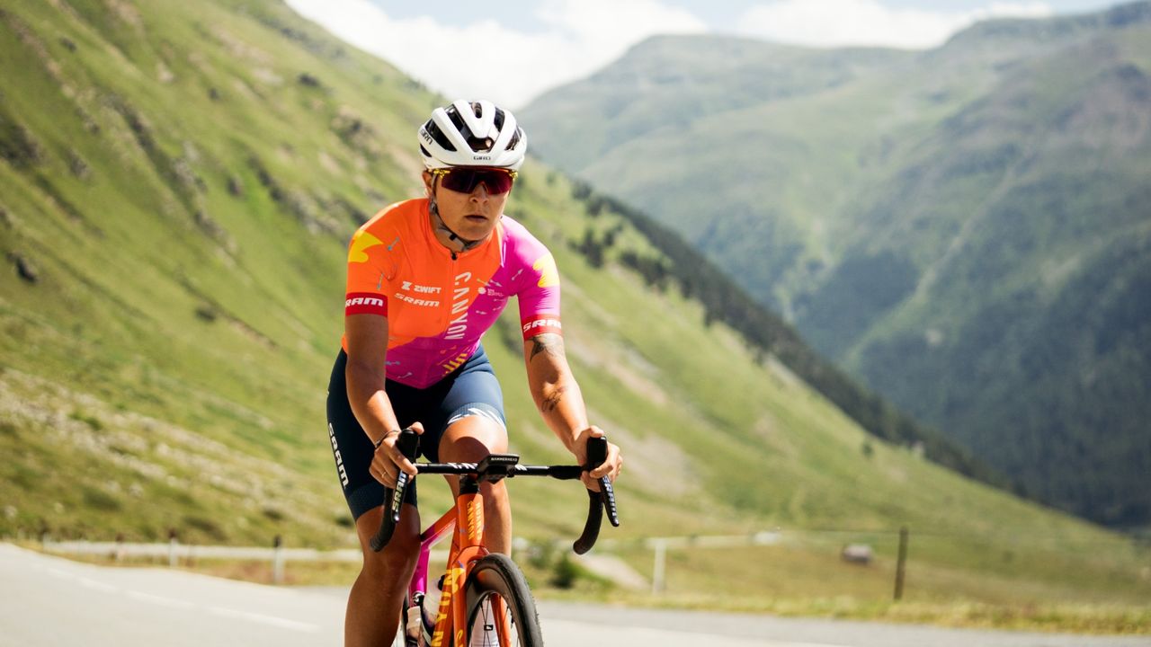 Canyon Sram rider in custom tour de france femmes kit riding up mountain