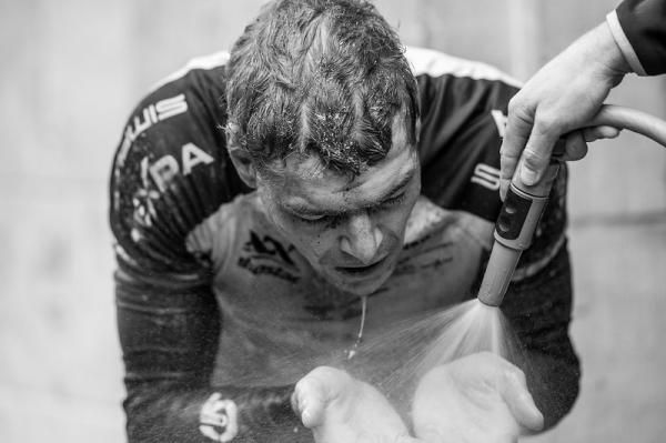 A rider wipes of stage 2 grime
