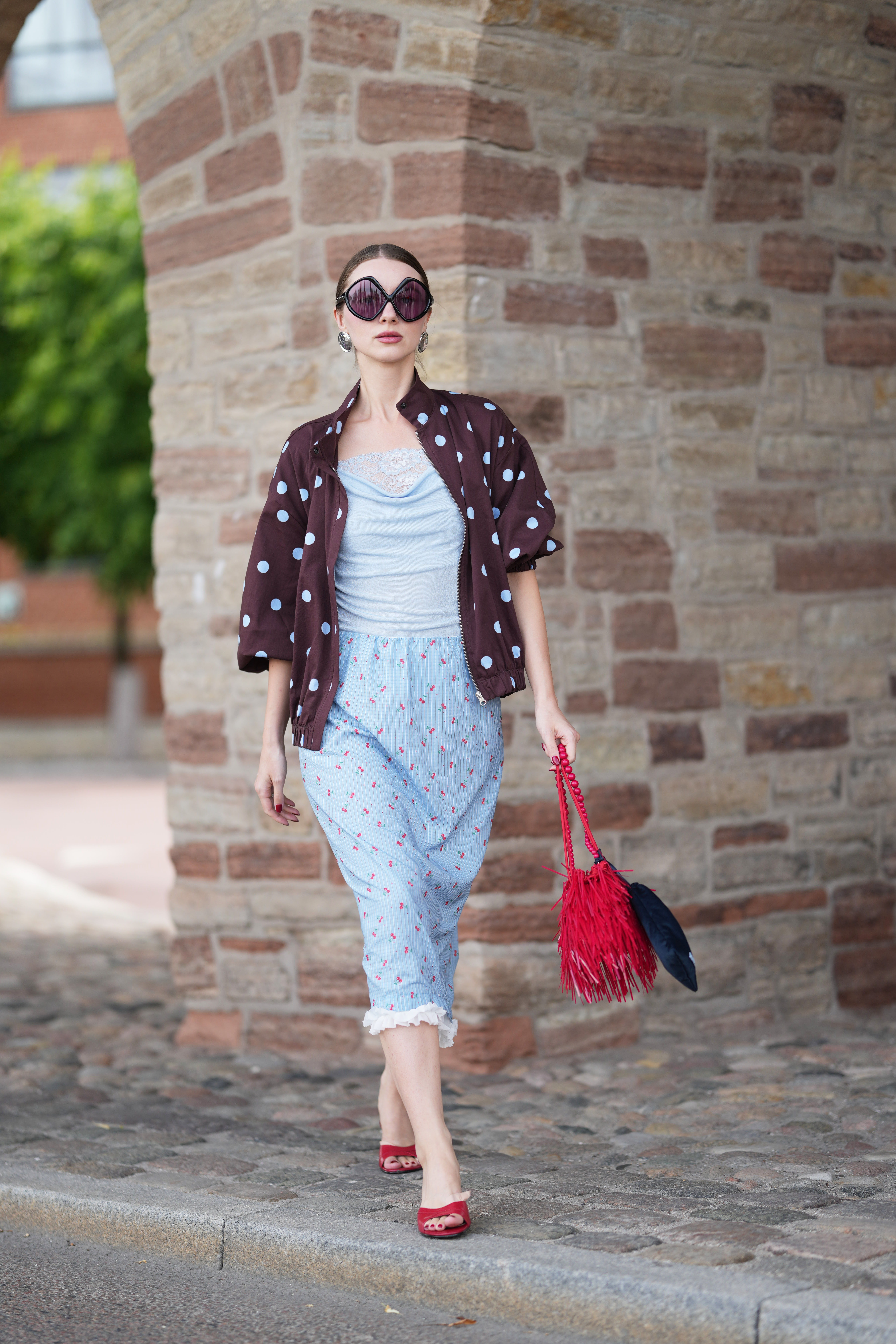 A guest at Copenhagen Fashion Week wore the red-and-blue color combination trend