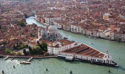 A aerial image of the city of Venice with waterways running through the city.