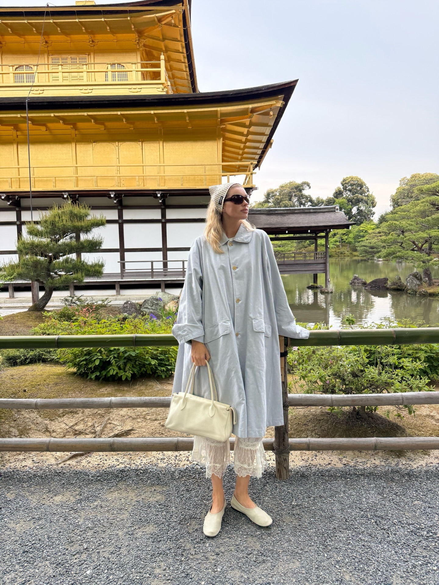 Elsa Hosk wearing petticoat pants with a trench coat and flats in Tokyo