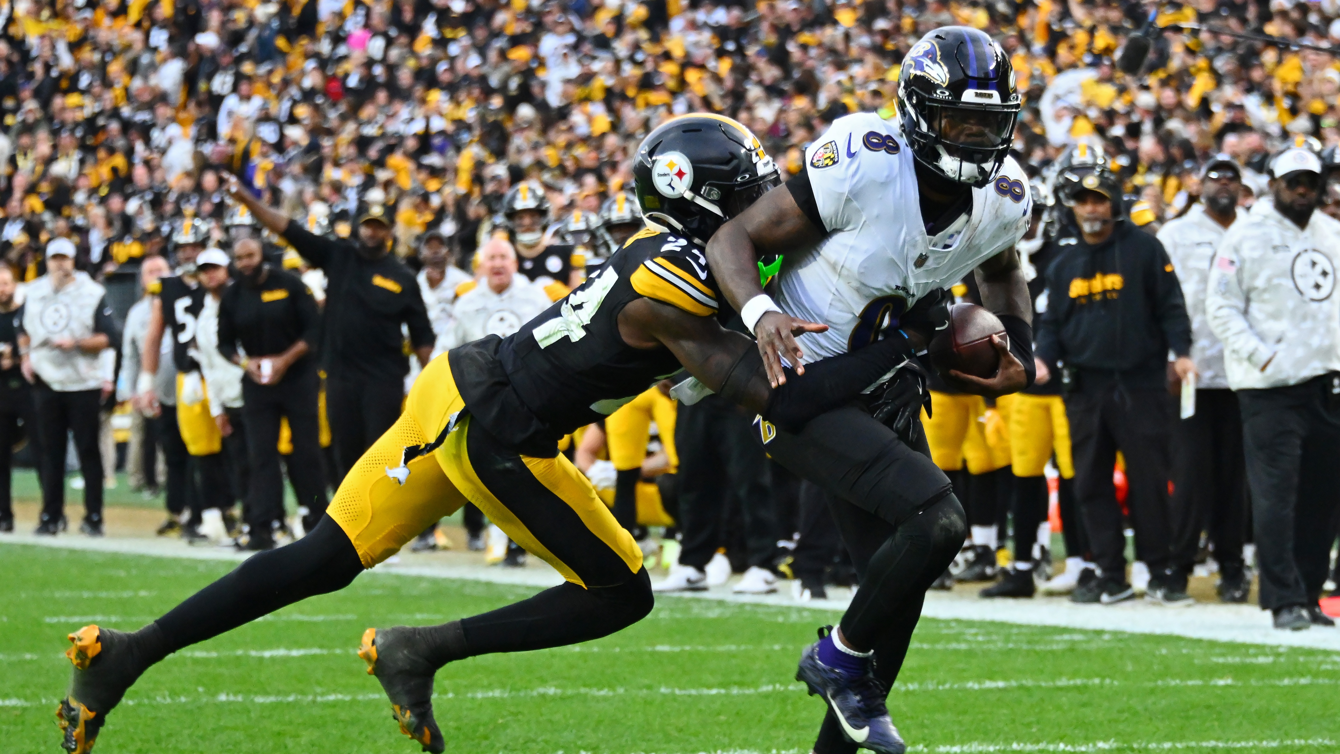 Joey Porter Jr. #24 of the Pittsburgh Steelers tackles Lamar Jackson #8 of the Baltimore Ravens short of the end zone to stop two point conversion attempt during the fourth quarter at Acrisure Stadium on November 17, 2024 in Pittsburgh, Pennsylvania.