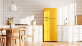 A yellow refrigerator in a white kitchen