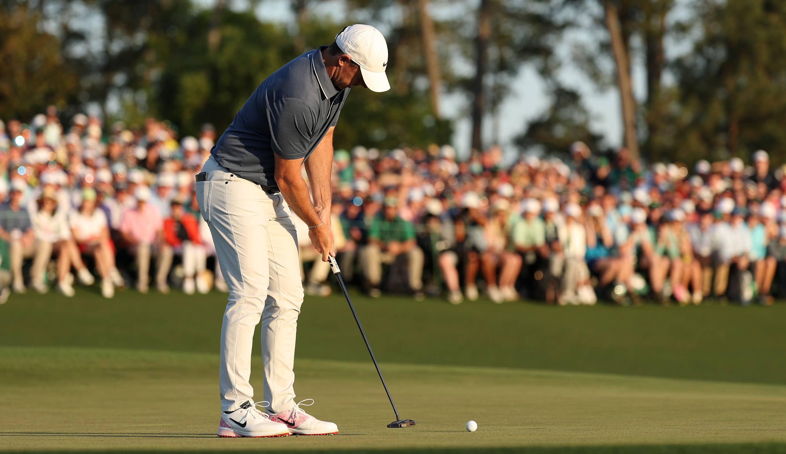 Rory McIlroy hits a putt on the 18th green at Augusta National